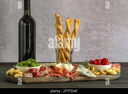 Appetizers board with different italian antipasti, cheese, charcuterie, snacks and wine.  Stock Photo