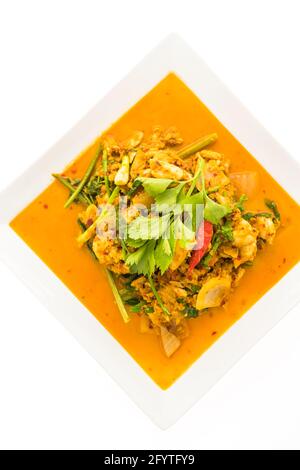 Stir fried crab with curry in white plate isolated on white background - Seafood style Stock Photo