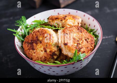 Healthy dinner. Chicken cutlets in a bowl on a dark background. Stock Photo