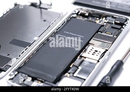 Professional occupation services concept - repairing modern smartphone motherboard in a professional laboratory in close-up Stock Photo
