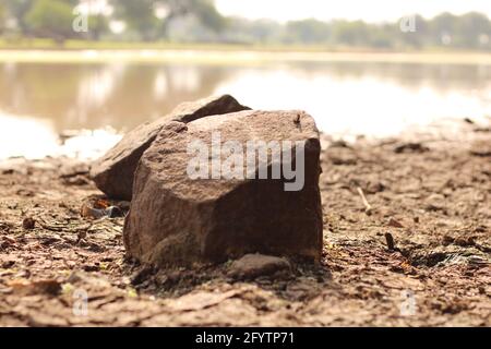 A stone using for washing cloths in pond or small tank Stock Photo