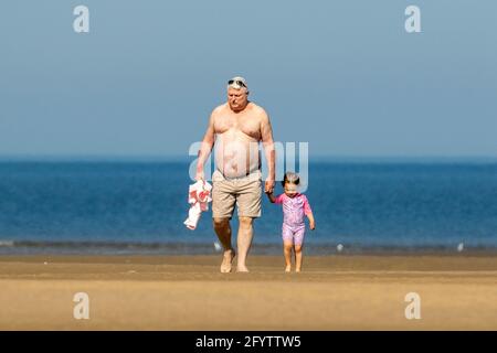 Father & daugher on the beach at Southport, Merseyside, 30 May 2021.  People at the seaside in Southport enjoying a day of fine warm sunshine and clear blue skies on a gorgeous Bank Holiday weekend.  Credit: Cernan Elias/Alamy Live News Stock Photo