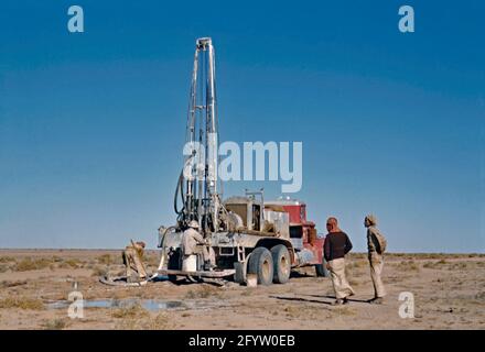 Oil exploration by the petroleum company Aramco in Saudi Arabia c. 1955. Here a mobile drill rig on the back of a truck is test drilling in the desert. Saudi Aramco (now the Saudi Arabian Oil Company and formerly Arabian-American Oil Company) is a Saudi Arabian petroleum and natural gas company based in Dhahran. In 1944 the company name was changed from California-Arabian Standard Oil Company to Arabian-American Oil Company (or Aramco) – a vintage 1950s photograph. Stock Photo