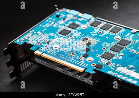 A blue board with chips and a gaming graphics card processor. Progressive cooling system for the video chip, processor and memory. Computer Details Stock Photo