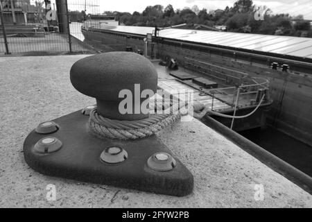 A grayscale shot of an old metal bollard Stock Photo