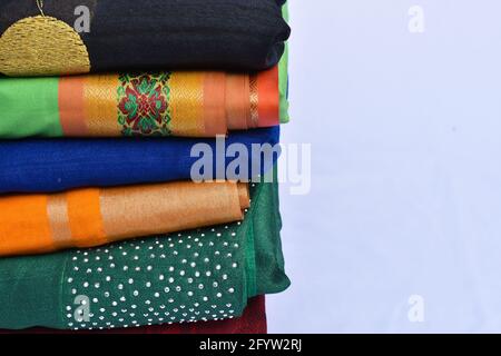 A stack of folded colorful sweaters isolated on sleek background with a copy space Stock Photo
