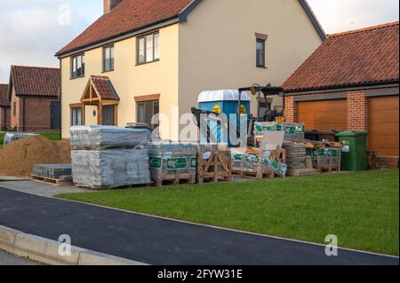 A newly built house with building materials in the drive way Stock Photo