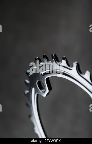 The teeth of the bicycle front star system on a dark background. Selective Focus Stock Photo