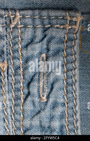 Buttonhole in a light blue denim shirt Stock Photo