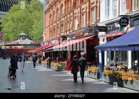 Visitors enjoy the restaurants in Irving Street, London, UK Stock Photo