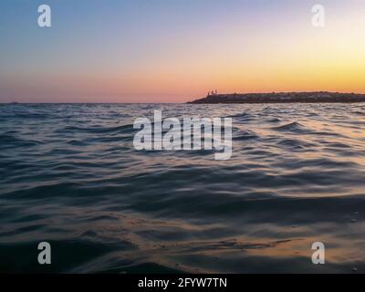 Mesmerizing view of sunset on the sea in Italy, surface level shot Stock Photo