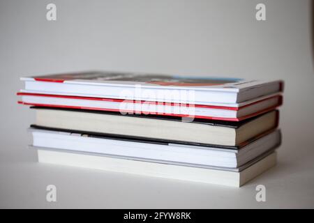 stack of different books with a side on a white background Stock Photo