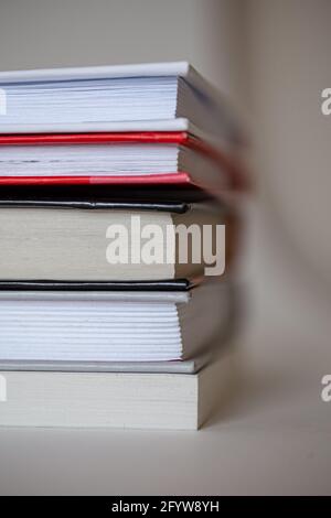 stack of different books with a side on a white background Stock Photo