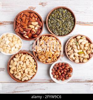 Different kind of nuts in wooden bowls Stock Photo