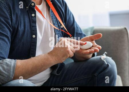 Hand pushing panic button on emergency equipment for old people Stock Photo