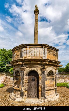 Old worn sandstone mercat or market cross, Prestonpans on a sunny day, East Lothian, Scotland, UK Stock Photo