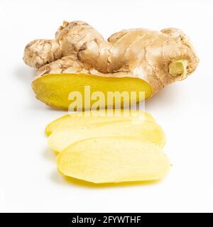 sliced fresh ginger root on gray plate close up Stock Photo