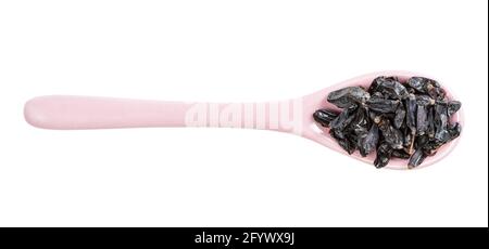 top view of ceramic spoon with black barberry fruits isolated on white background Stock Photo