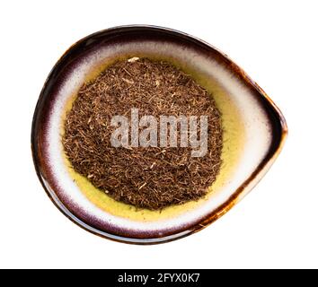top view of grinded dried corn silk in ceramic bowl isolated on white background Stock Photo