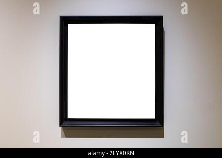 square black picture frame with cutout canvas on gray horizontal wall Stock Photo