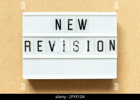 Lightbox with word new revision on wood background Stock Photo