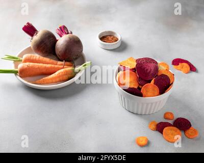 homemade healthy vegetable chips in bowl on gray concrete table. healthy eating concept. horizontal image. copy space. Stock Photo