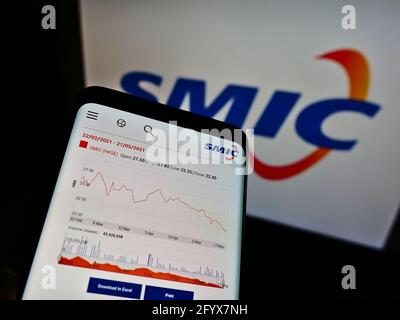 Cellphone with website of Semiconductor Manufacturing International Corporation (SMIC) on screen with logo. Focus on top-left of phone display. Stock Photo