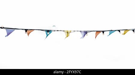 Bunting and light bulbs against a white sky Stock Photo