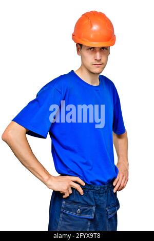 Studio portrait of a confident worker in a construction helmet looking at the camera and holding his hands on his belt. A young guy of Caucasian appearance is isolated on a white background. Stock Photo