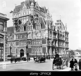 Exterior view, looking north across the intersection of 5th Avenue and 57th Street, of the Cornelius Vanderbilt II House, New York, New York, May 1910. The home, built in 1883 was the largest private home in Manhattan. Visible above it is the Plaza Hotel. (Photo by Burton Holmes) Stock Photo