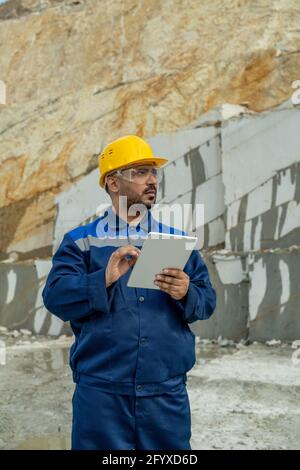 Middle aged builder using tablet at building place Stock Photo