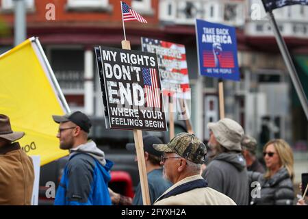 Bloomsburg, United States. 29th May, 2021. Members of We The People of Columbia County hold placards during a rally at Bloomsburg's Market Square.About 100 self-described patriots marched from Bloomsburg Town Park to Market Square for a pro-freedom rally during the Memorial Day weekend. Credit: SOPA Images Limited/Alamy Live News Stock Photo