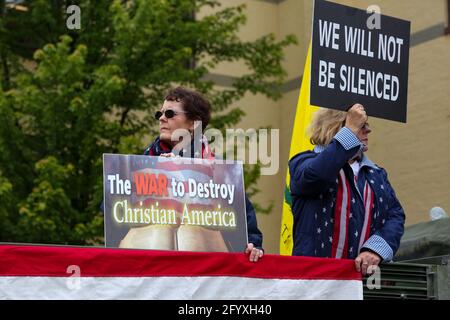 Bloomsburg, United States. 29th May, 2021. Members of We The People of Columbia County hold placards during a rally at Bloomsburg's Market Square.About 100 self-described patriots marched from Bloomsburg Town Park to Market Square for a pro-freedom rally during the Memorial Day weekend. Credit: SOPA Images Limited/Alamy Live News Stock Photo