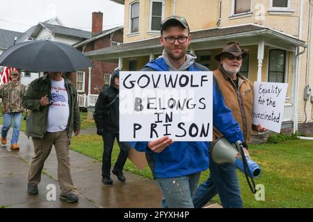 Bloomsburg, United States. 29th May, 2021. Members of We The People of Columbia County march during the rally.About 100 self-described patriots marched from Bloomsburg Town Park to Market Square for a pro-freedom rally during the Memorial Day weekend. Credit: SOPA Images Limited/Alamy Live News Stock Photo