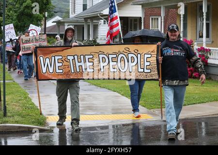 Bloomsburg, United States. 29th May, 2021. Members of We The People of Columbia County march during the rally.About 100 self-described patriots marched from Bloomsburg Town Park to Market Square for a pro-freedom rally during the Memorial Day weekend. Credit: SOPA Images Limited/Alamy Live News Stock Photo