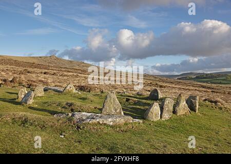 Nine Maidens cairn circle with Belstone Tor in the background Dartmoor UK Stock Photo