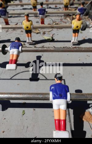 Old foosball table game with football soccer team figure players. Selective focus. Stock Photo