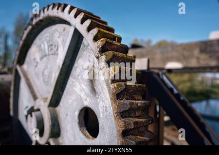 Large metal gear on a water sluice Stock Photo