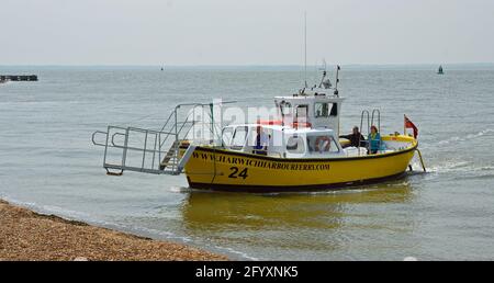 Harwich to Felixstowe and Shotley ferry takes up to twelve people across the busy estuary, port of Felixstowe in background. Stock Photo