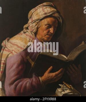 Old Woman Reading. Study of a reading old woman. The woman has passed in half, sitting behind a table on which a small book is, with a slightly opened book in the hands. To head a striped cloth. Stock Photo