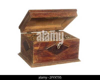 Antique wooden box with a key filled with coins isolated on a white background. Stock Photo