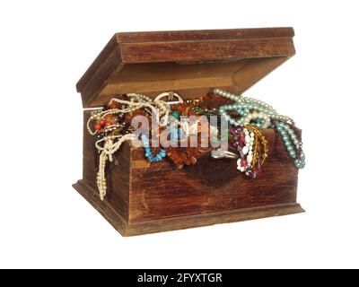 Antique wooden box with a key filled with all kinds of beads, ornaments and bijouterie isolated on a white background. Stock Photo