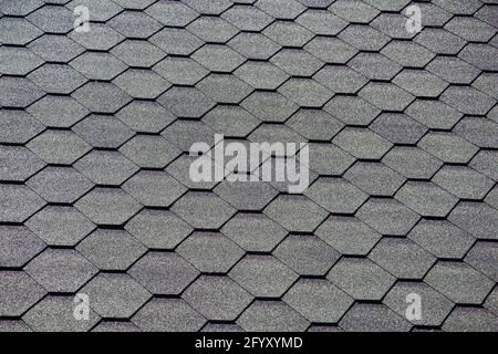 Black bitumen shingles on .the roof. close-up Stock Photo