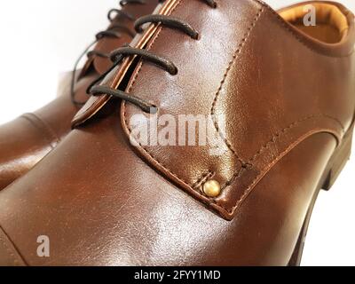 Classical male brown leather shoes in close-up on a white background Stock Photo