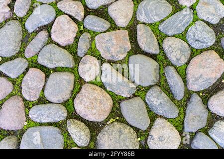 Paving stones background. Sidewalk and city roadway of the old town. Top view. Stock Photo