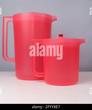 Red water jug isolated on a grey and white background Stock Photo