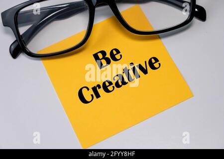 Be creative words on a yellow sticky notes. Stock Photo