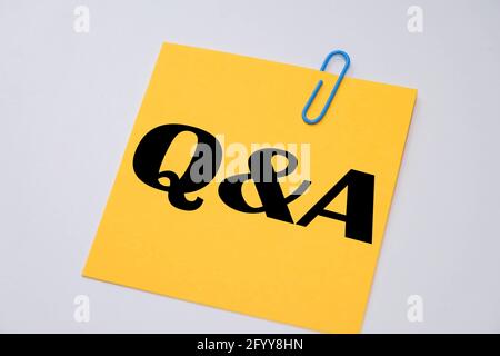 Q&A words on a yellow sticky notes. Stock Photo