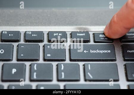 Delete button pressing a lot of times on keyboard, laptop keyboard close up Stock Photo