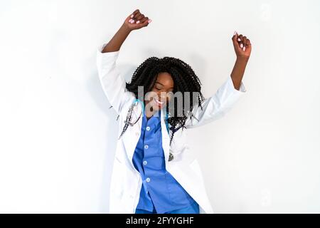 African American Woman in medical uniform dancing in doctor office during break Stock Photo